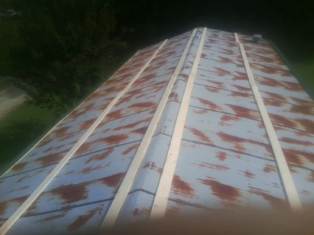 Rusted metal roof panels with new wood purlins before replacement — Storm Damage Roof Repair in San Fernando by Roofing Brothers