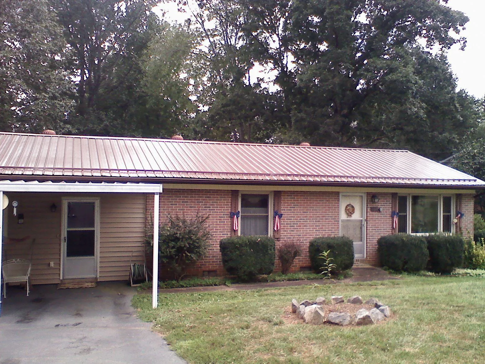 Bronze metal roof and carport on a brick ranch home — Roof Repair work by our crew in San Fernando